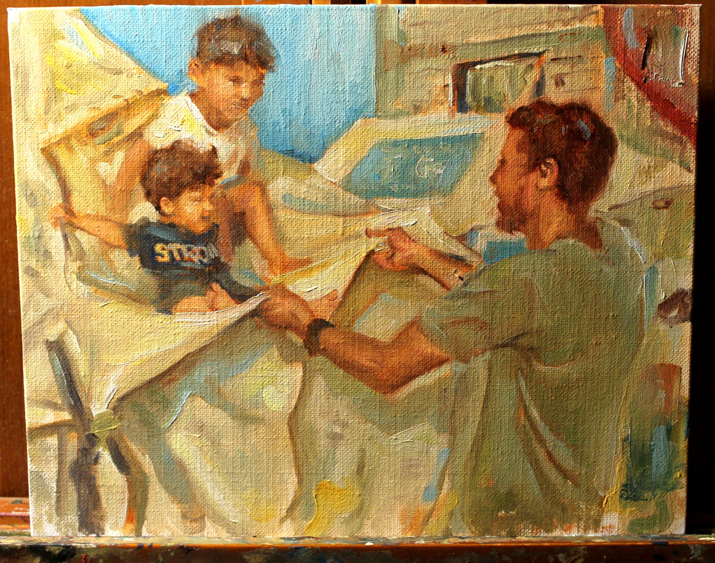 Mohammed plays with his children Iman and Adam, making them laugh despite the suffering this family has gone through.